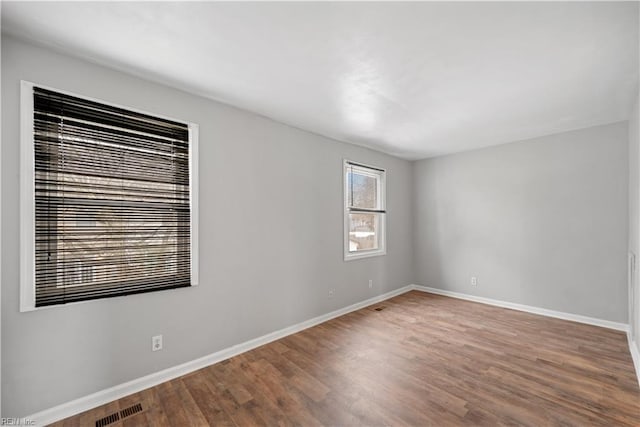 spare room with hardwood / wood-style floors