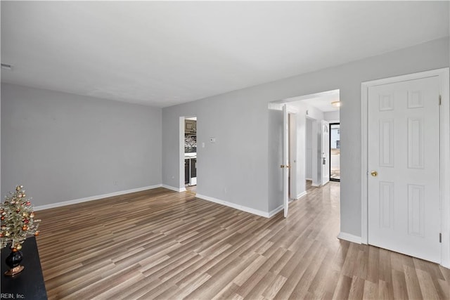 unfurnished room with light hardwood / wood-style floors