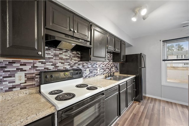 kitchen featuring sink, range with electric cooktop, light wood-type flooring, and decorative backsplash