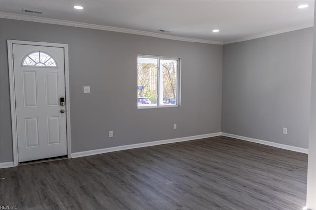 entryway with dark wood-style floors, baseboards, and crown molding