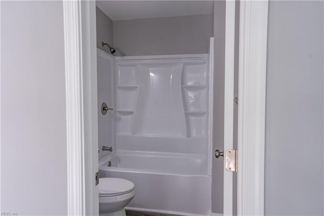 bathroom with bathtub / shower combination and toilet