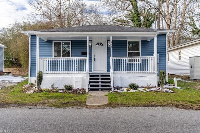 bungalow featuring covered porch and stairs