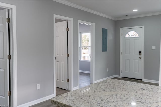 entryway with baseboards, plenty of natural light, ornamental molding, and wood finished floors