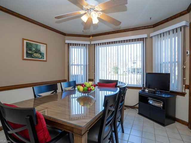 dining room featuring light tile patterned floors, ornamental molding, a wealth of natural light, and a ceiling fan