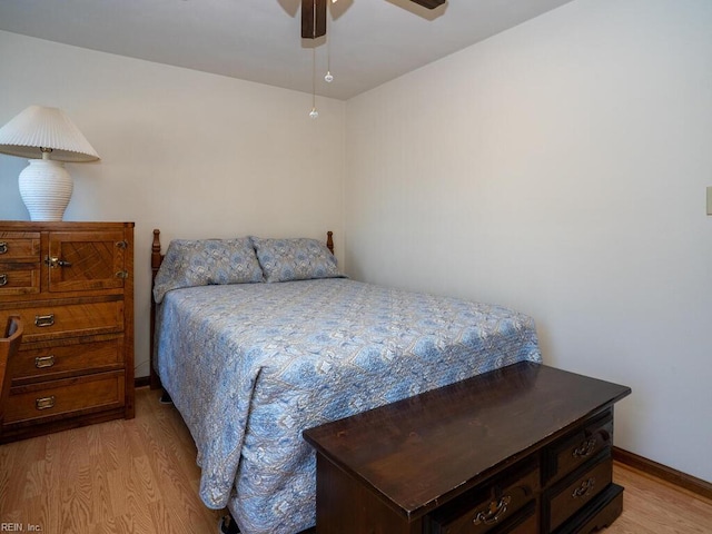 bedroom with ceiling fan, light wood-type flooring, and baseboards