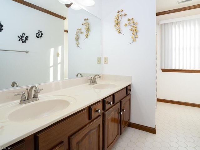 full bath featuring double vanity, visible vents, baseboards, and a sink