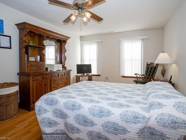 bedroom with ceiling fan and light wood-type flooring