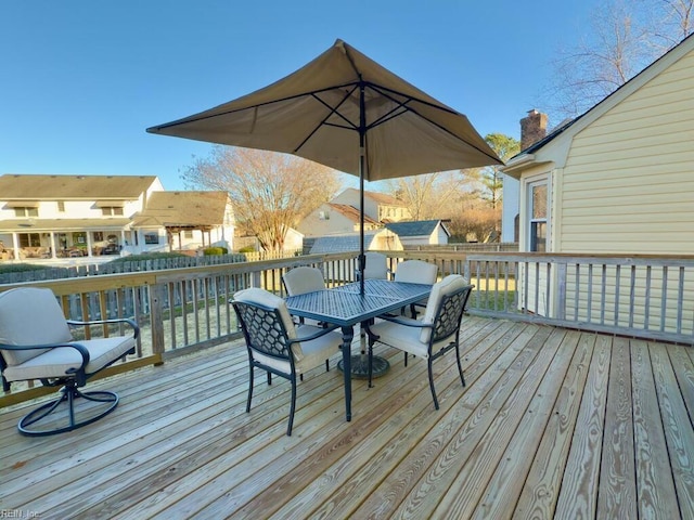 wooden terrace featuring outdoor dining area