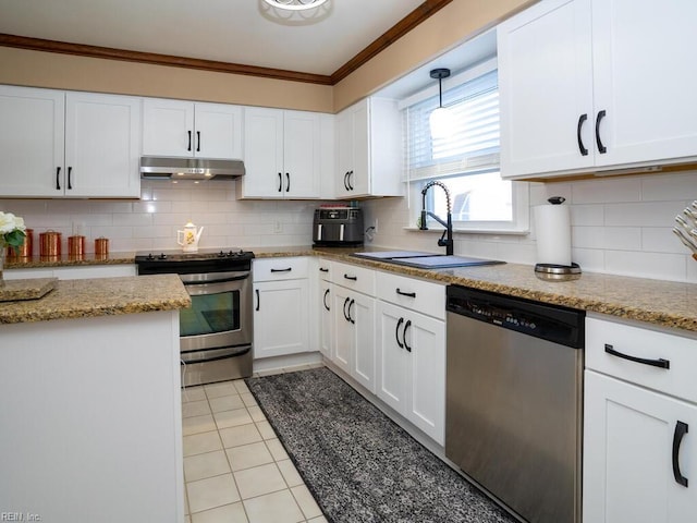 kitchen with under cabinet range hood, a sink, white cabinets, appliances with stainless steel finishes, and crown molding