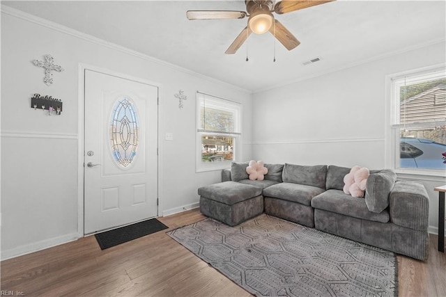 entrance foyer featuring ornamental molding, hardwood / wood-style flooring, and ceiling fan