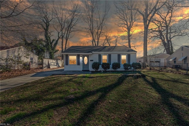 single story home with a lawn