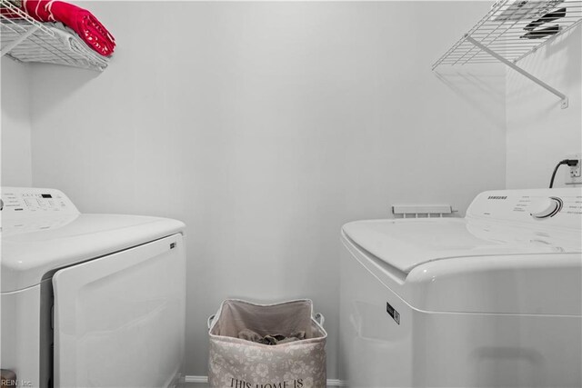 clothes washing area with washing machine and dryer