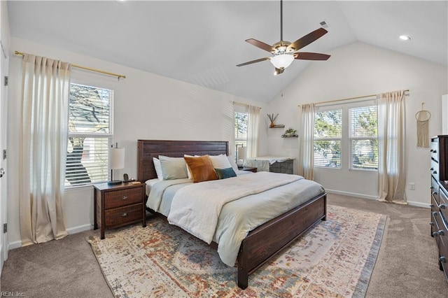 bedroom with lofted ceiling, multiple windows, baseboards, and light colored carpet