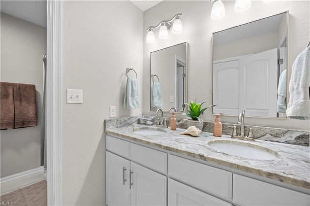 bathroom featuring double vanity and a sink