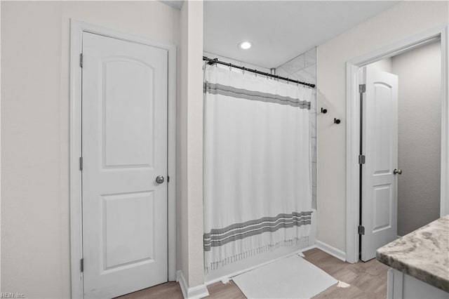 full bathroom featuring wood finished floors, vanity, and recessed lighting