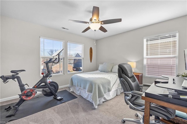 carpeted bedroom with ceiling fan, visible vents, and baseboards