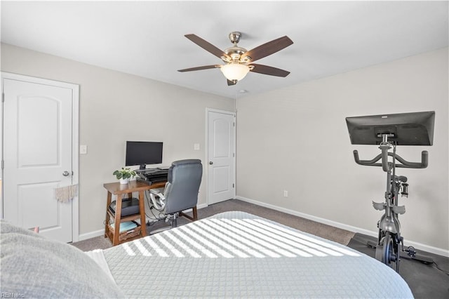 bedroom with a ceiling fan, dark colored carpet, and baseboards