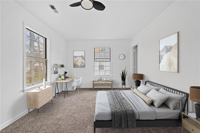 carpeted bedroom featuring baseboards and visible vents