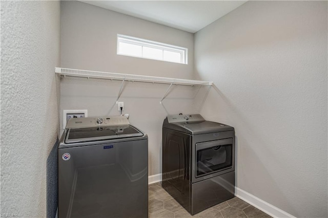 washroom with tile patterned flooring and washing machine and clothes dryer