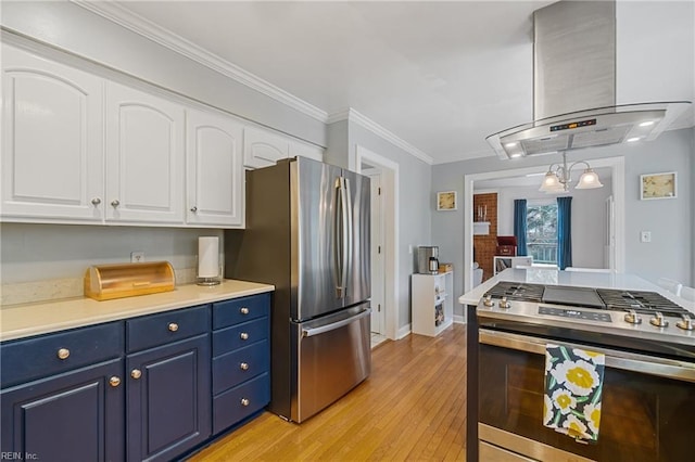 kitchen with stainless steel appliances, white cabinetry, light countertops, island exhaust hood, and decorative light fixtures