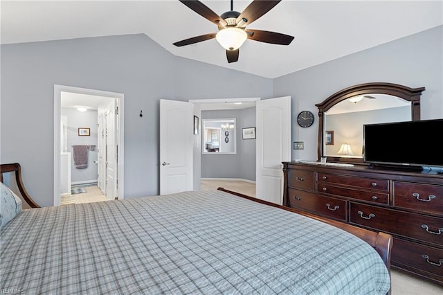 bedroom with ensuite bath, vaulted ceiling, light colored carpet, and ceiling fan