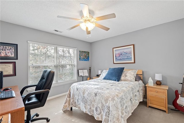 bedroom featuring light carpet, baseboards, visible vents, a textured ceiling, and a ceiling fan