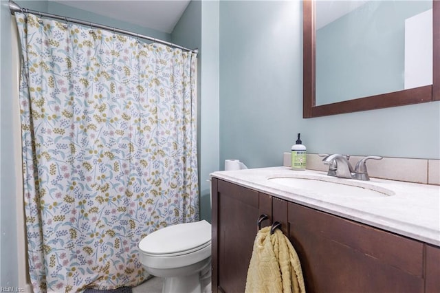 bathroom featuring toilet and vanity