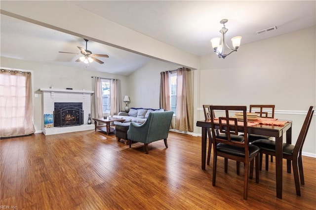 dining area with a fireplace, visible vents, wood finished floors, and baseboards