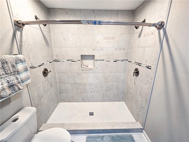 full bath with a shower stall and toilet