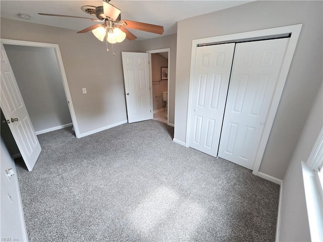 unfurnished bedroom with ceiling fan, a closet, dark carpet, and baseboards