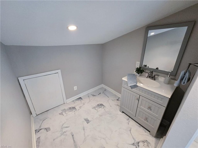 bathroom featuring marble finish floor, recessed lighting, vaulted ceiling, vanity, and baseboards