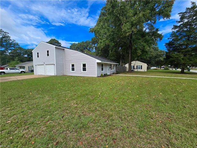 view of front facade featuring an attached garage, a storage shed, a front lawn, and concrete driveway