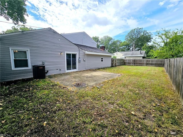 rear view of property featuring central air condition unit, a yard, a fenced backyard, and a patio