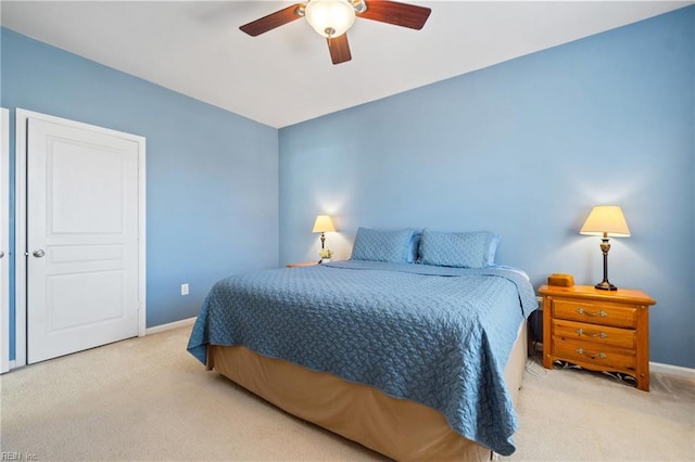 bedroom featuring light carpet, ceiling fan, and baseboards