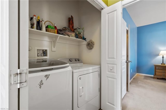 laundry area featuring baseboards, laundry area, washing machine and clothes dryer, and light colored carpet