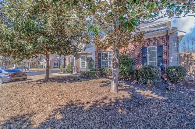 obstructed view of property featuring brick siding