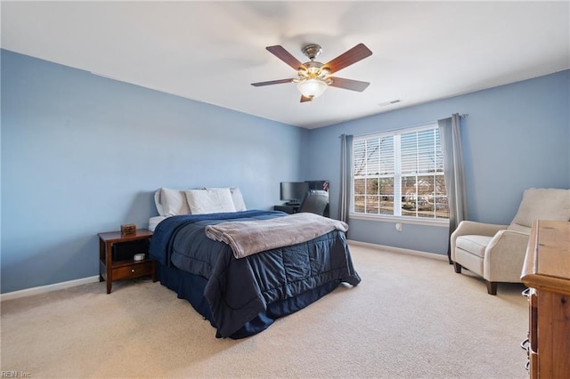 bedroom featuring baseboards, visible vents, a ceiling fan, and light colored carpet