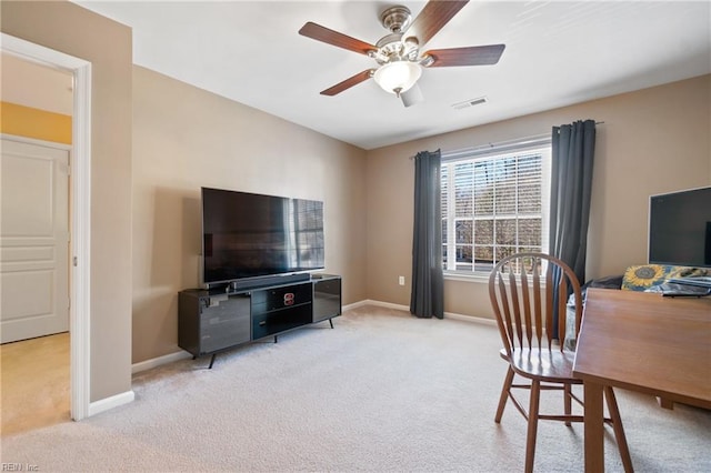 office with a ceiling fan, visible vents, light carpet, and baseboards