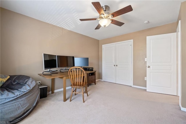 home office featuring ceiling fan, light colored carpet, and baseboards