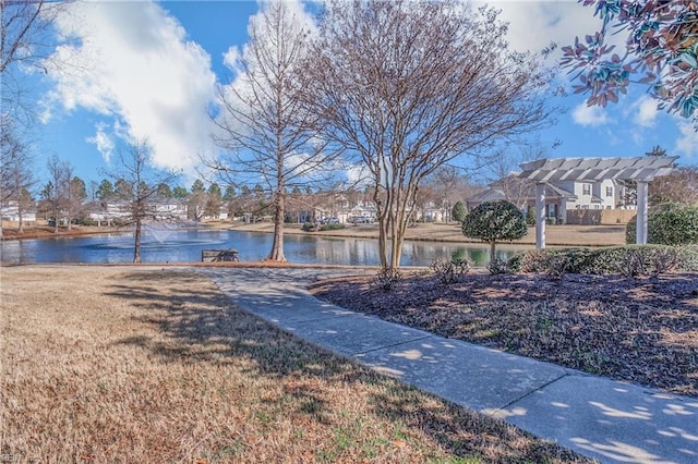 view of yard featuring a water view and a residential view