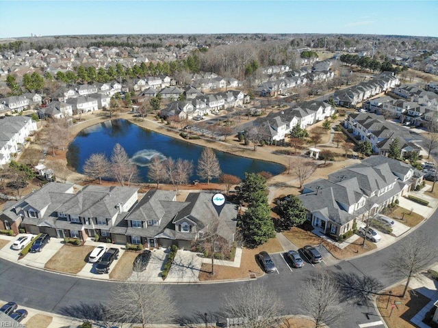 birds eye view of property with a water view and a residential view