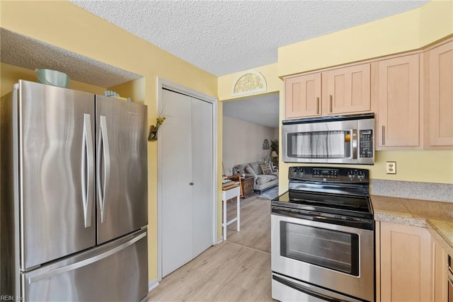 kitchen featuring appliances with stainless steel finishes and light brown cabinets