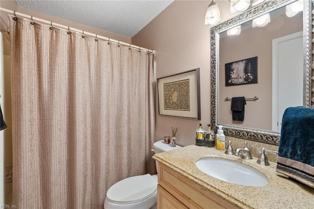 full bathroom with a textured ceiling, vanity, and toilet