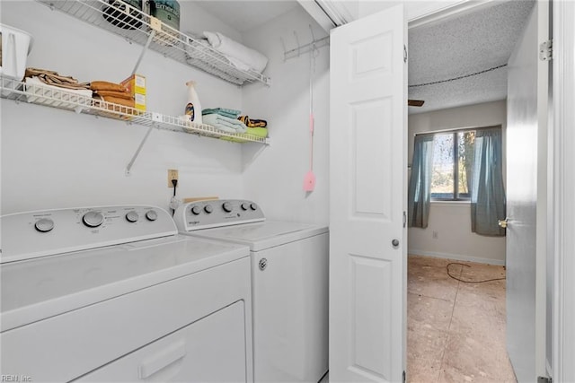 clothes washing area with laundry area, baseboards, and separate washer and dryer