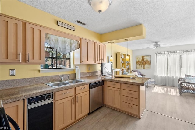 kitchen featuring tile countertops, a sink, dishwasher, and light brown cabinetry