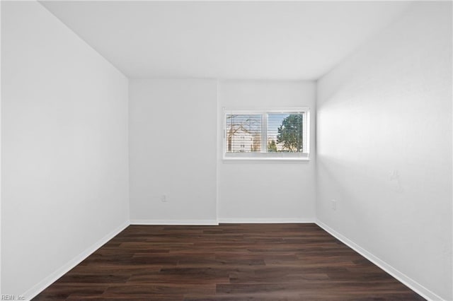 empty room featuring baseboards and wood finished floors