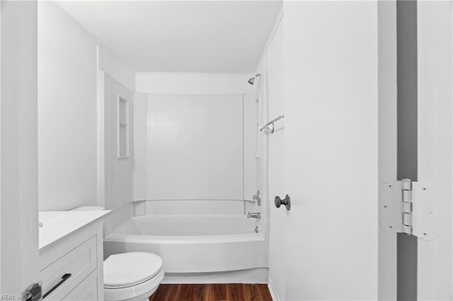 full bath featuring washtub / shower combination, vanity, toilet, and wood finished floors