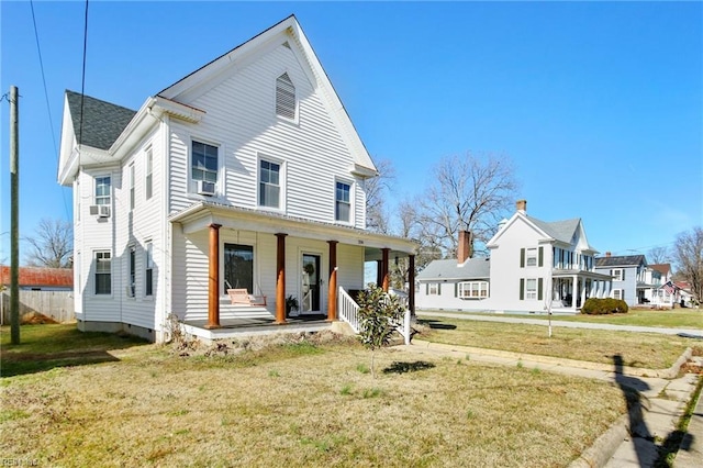 view of front of house with a porch, a front yard, and crawl space