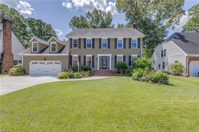 colonial inspired home featuring driveway, a front lawn, and an attached garage