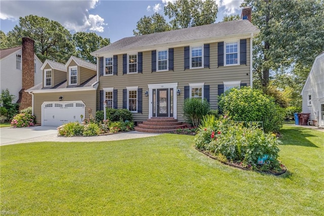 colonial home with a garage, driveway, and a front lawn